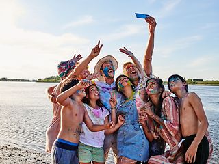 Family at the beach taking selfies