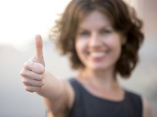 Woman showing "thumbs up".